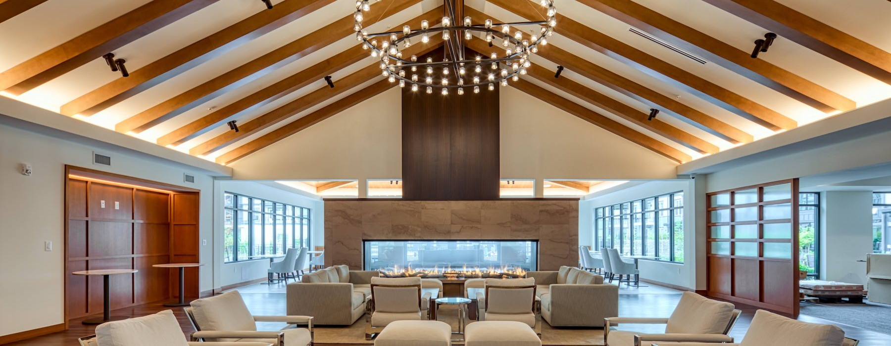 a large clubhouse with seating and a fireplace