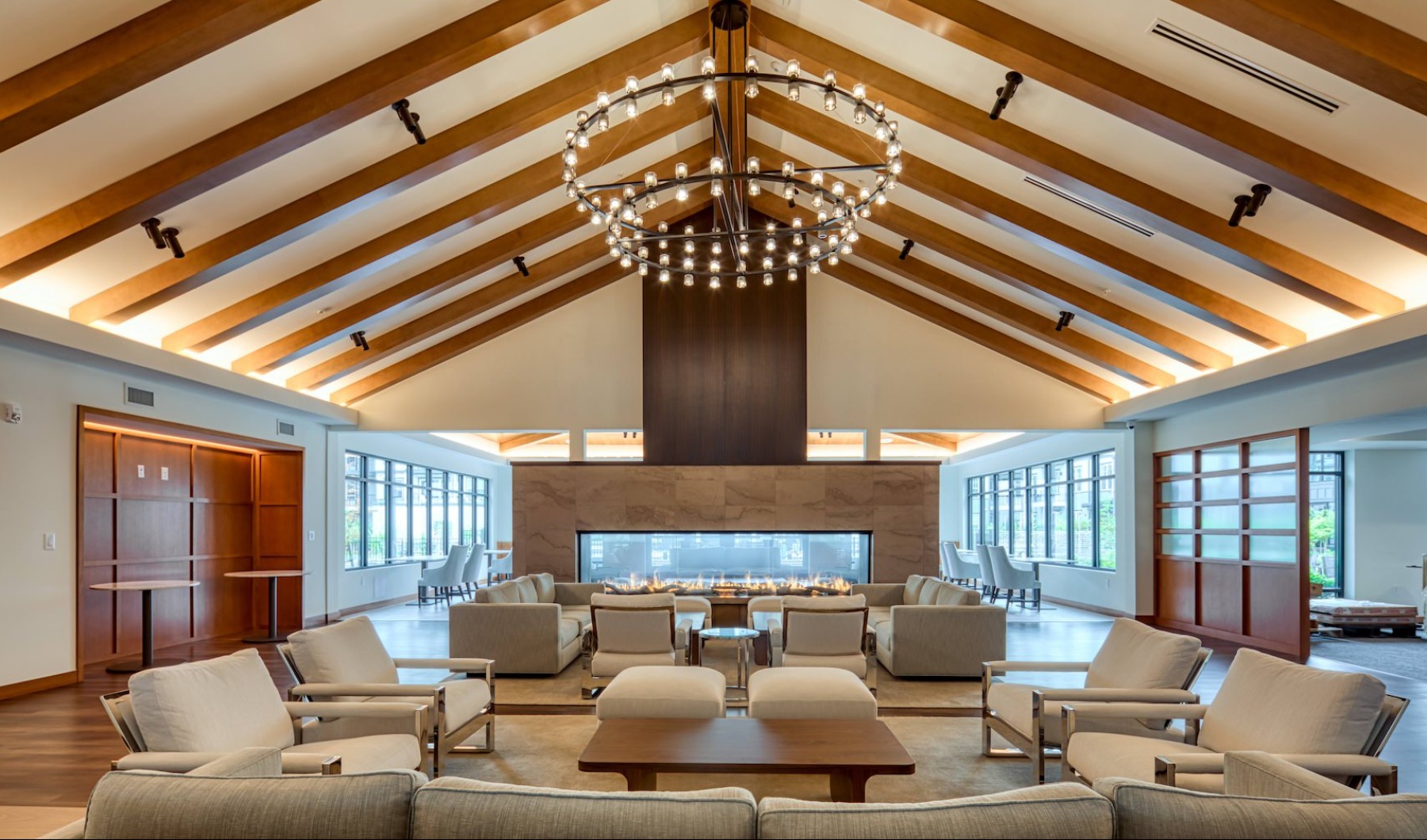 a large clubhouse with seating and a fireplace