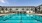 a large building with a pool in front of it