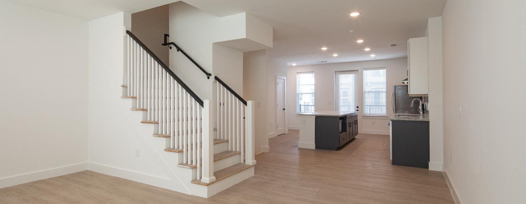 a large white room with a staircase