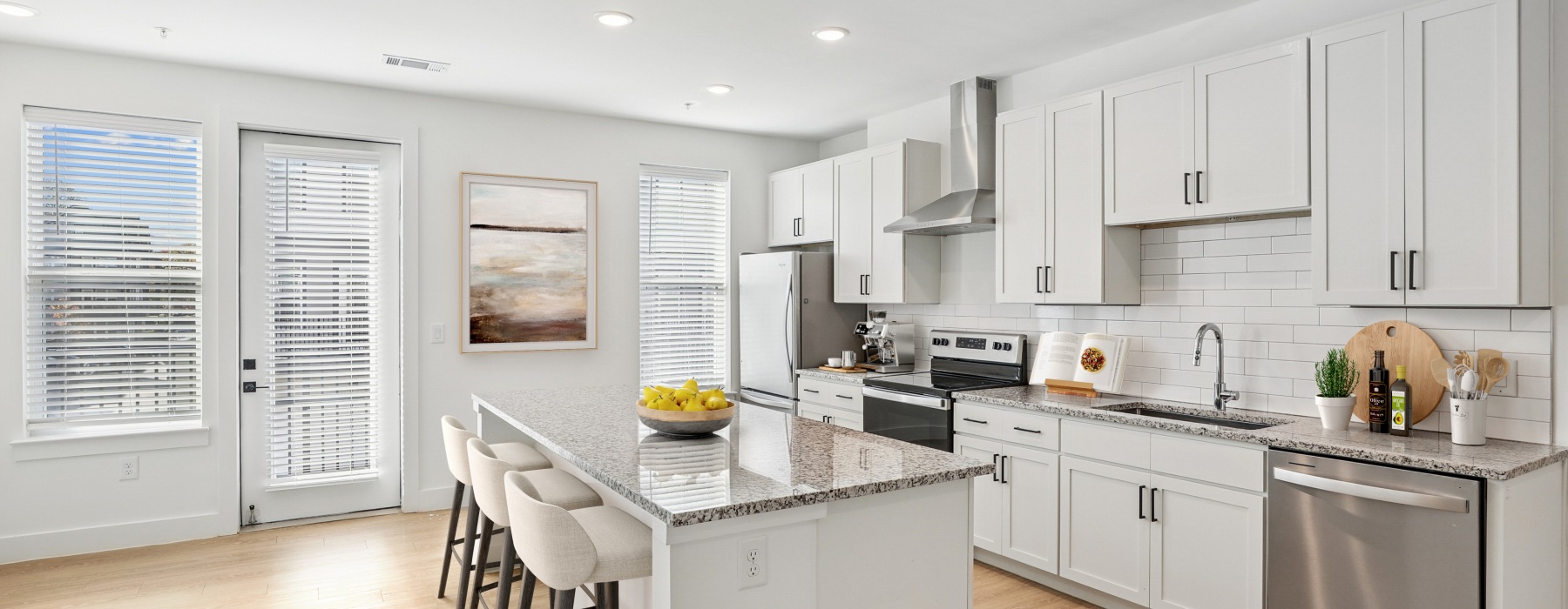 a kitchen with white cabinets