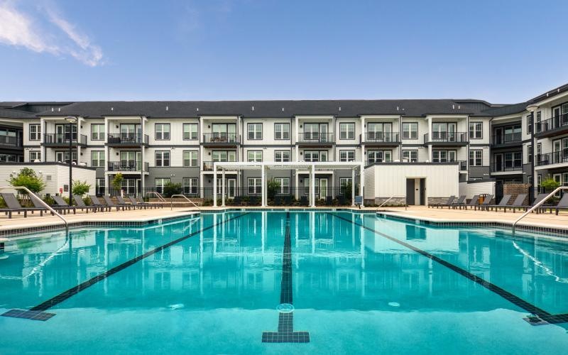 a large building with a pool in front of it
