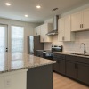 a kitchen with white cabinets
