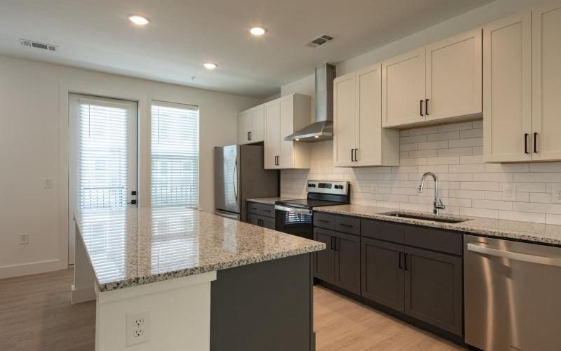 a kitchen with white cabinets