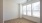 a room with a wood floor and windows