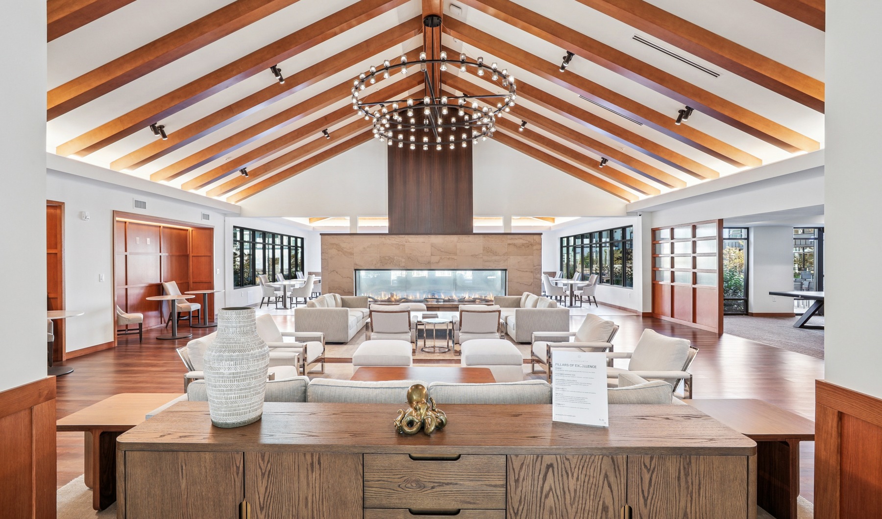 a large clubhouse with seating and a fireplace