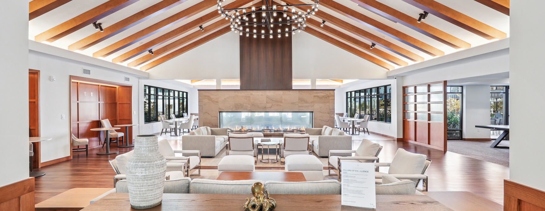 a large clubhouse with seating and a fireplace