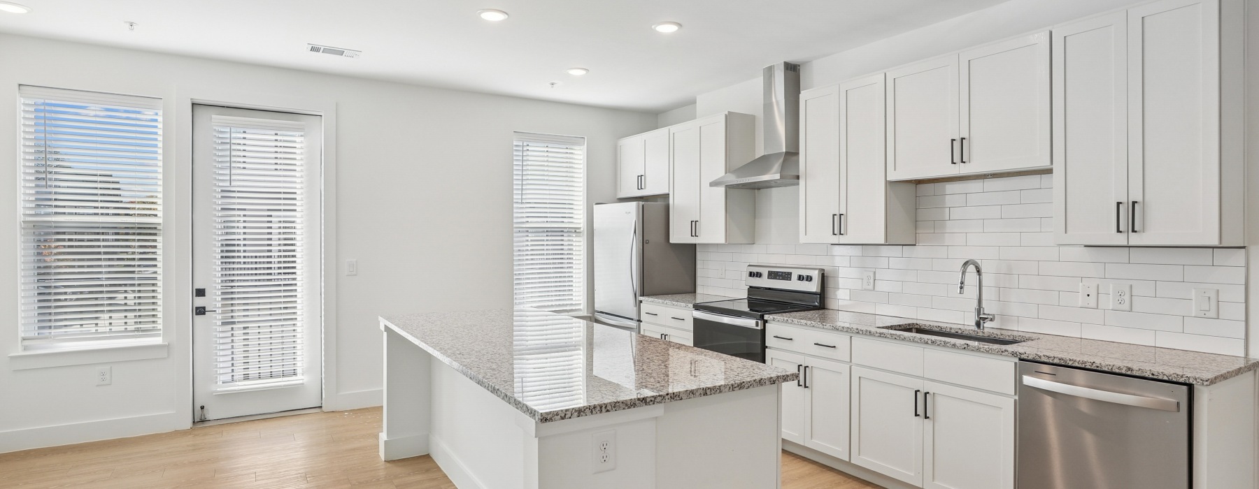 a kitchen with white cabinets