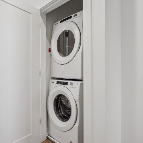 a white door with a full sized washer and dryer