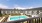 a swimming pool in front of a large building